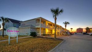 un edificio con un cartel delante en Chic 2BR Coastal Condo Shared Pool Near the Beach Costa Bahia 103, en Port Aransas
