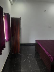 a bedroom with a wooden bed and a window at DS Villa in Noida