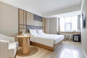 Ένα ή περισσότερα κρεβάτια σε δωμάτιο στο JI Hotel Beijing Yizhuang Economic Development Zone