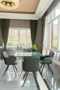 a dining room with a glass table and chairs at Highland Villas Royale Corp in Alfonso