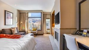 a hotel room with a bed and a large window at Beaver Creek Solace by AvantStay Resort Access with Pool Hot Tub Premier Avon Location in Avon