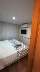 カンポ・グランデにあるFlat moderno em Campo Grande com fácil acessoの小さなベッドルーム(スーツケース付きのベッド付) +39枚の写真