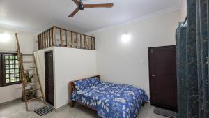 a bedroom with a bed and a ladder and a bunk bed at REJOICE Homestay - 1BHK private stay in Kalyānpur