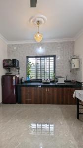 a kitchen with a large counter and a window at REJOICE Homestay in Kalyānpur