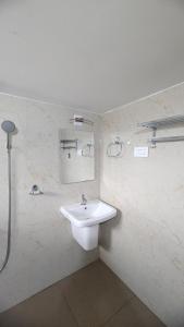 a bathroom with a sink and a mirror at REJOICE Homestay in Kalyānpur