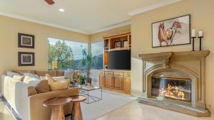 a living room with a couch and a fireplace at Hilltop Estate w Pool Hot Tub Fire Pit Views Cleveland Vista by AvantStay in Murrieta