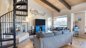 a living room with a couch and a fireplace at Steps to Beach w PatioDeck Foosball Happy Bottom Beach House by AvantStay in Oceano