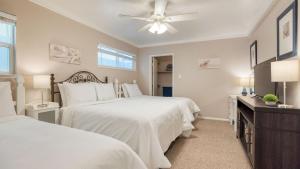 a bedroom with two beds and a ceiling fan at Steps to Beach w PatioDeck Foosball Happy Bottom Beach House by AvantStay in Oceano