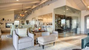 a living room with two chairs and a glass wall at Private Pool Firepit Wine Room Near Top Paso Wineries Devi Ranch in Paso Robles