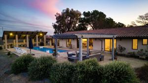 a house with a swimming pool in front of it at Private Pool Firepit Wine Room Near Top Paso Wineries Devi Ranch in Paso Robles