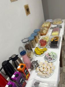 a table with many different types of food on it at Hotel Colombo in São Lourenço