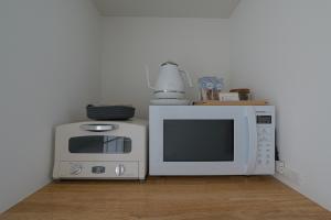 a kitchen with two microwaves and a microwave at 星降る別邸WANASA in Kannoura +5 photos