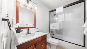 a white bathroom with a sink and a toilet at Cozy Forest Hideaway in Incline Village Private Balcony Sierra Solace by AvantStay in Incline Village +23 photos