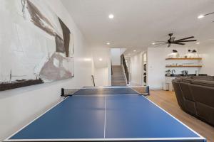 a large ping pong table in a living room at The Fish Bowl townhouse in St. George +62 photos