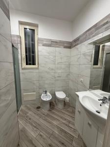a bathroom with a toilet and a sink at Metro Stay piscinola in Naples