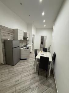 a kitchen and dining room with a table and chairs at Metro Stay piscinola in Naples