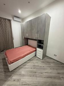a small bedroom with a bed and a cabinet at Metro Stay piscinola in Naples