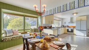 a kitchen and living room with a table and chairs at Walk to Beach Shops Fireplace Patio Dining Firepit at Manzanita Ave. in Manzanita