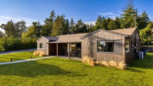 a house with a large yard with grass at Walk to Beach Shops Fireplace Patio Dining Firepit at Manzanita Ave. in Manzanita
