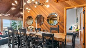 a dining room with a table and chairs and mirrors at Scenic North Shore Stay w Games Near Snow Summit Lakeview Lodge by AvantStay in Fawnskin