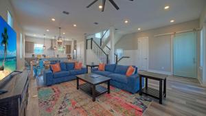 a living room with a blue couch and a table at La Concha Blvd 31 - in Padre Island