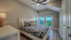 a bedroom with a bed and a ceiling fan at La Concha Blvd 31 - in Padre Island +43 photos