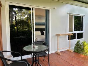 a patio with a table and chairs on a deck at The Green Resort in Ko Chang