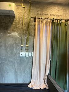 a curtain is hanging in a room with green curtains at Mơ House Eco Homestay on hill in Phú Quốc +49 photos