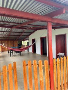 a patio with a hammock and a table and chairs at Finca hotel VillaLuna in Mesetas +1 photo