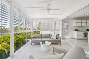 a living room with a couch and a table at The Cheeky Palm - Beachy, enjoy a cheeky cocktail! in Woolgoolga