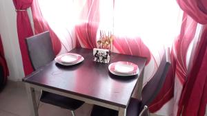 a table with two plates on it in front of a window at Ecotropicfarmhouse in Cerro Azul