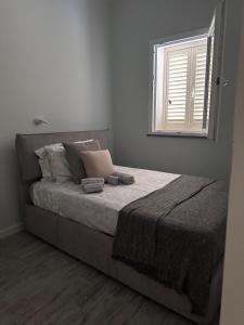 a bedroom with a large bed with a window at Leyand exclusive House in Torre del Lago Puccini