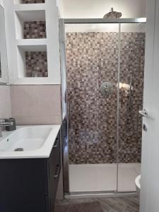 a bathroom with a shower with a sink and a toilet at Leyand exclusive House in Torre del Lago Puccini
