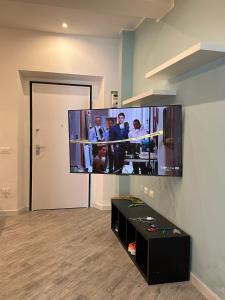 a flat screen tv hanging on a wall in a room at Leyand exclusive House in Torre del Lago Puccini