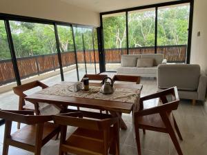 a living room with a table and chairs and a couch at The Empire in Tulum in Tulum