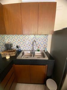 a small kitchen with a sink and a toilet at The Empire in Tulum in Tulum +16 photos