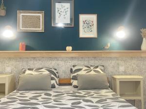 a bedroom with a bed with two pillows at Gîte au Bord de la Rivière avec Terrasse, Internet et Jardin - FR-1-653-271 in Saint-Maurice-des-Lions