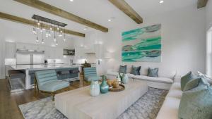 a living room with a couch and a kitchen at Priv Heated Pool Spa Golf Cart Included 7BDR Sleeps 20 30A Serenity Sands in Santa Rosa Beach