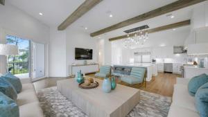 a living room with a couch and a table at Priv Heated Pool Spa Golf Cart Included 7BDR Sleeps 20 30A Serenity Sands in Santa Rosa Beach