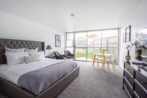 a bedroom with a large bed and a table and chairs at Bay View Breeze in Lorne