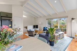 a living room with a couch and a table at The Balcony - pet friendly! in Torquay