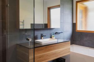 a bathroom with a sink and a mirror at The Balcony - pet friendly! in Torquay +31 photos