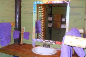 a bathroom with a sink and a mirror at Mariposa del Mar Oceanfront villa with private pool in Juticalpa +9 photos