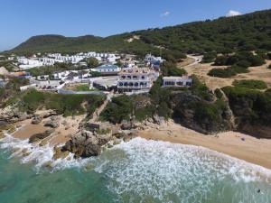 an aerial view of a resort on a beach at Hostal Mar de Frente in Los Caños de Meca