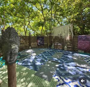 a garden with a statue in the middle at Puerto idilio beach resort in Isla Grande +1 photo