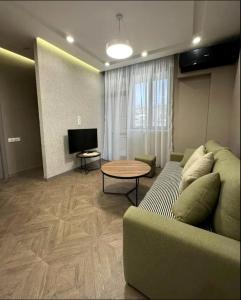 a living room with a couch and a table at Nice Stay Near Center in Yerevan