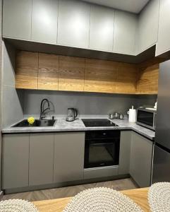 a kitchen with a sink and a stove at Nice Stay Near Center in Yerevan