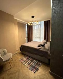 a bedroom with a bed and a window and a chair at Nice Stay Near Center in Yerevan