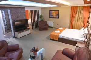 a hotel room with a bed and a flat screen tv at Hotel Rothmans-Breakfast - Free parking - Lobby in Bansko +177 photos