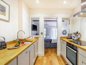 a kitchen with white cabinets and wooden counter tops at 1 Bed in Richmond oc-88054 in Richmond